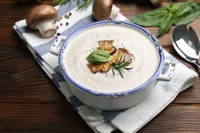 Photo of Delicious homemade mushroom soup served on wooden table