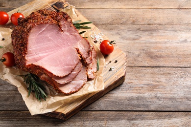 Delicious ham on wooden table, above view with space for text. Christmas dinner