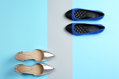 Different female shoes on color background, top view