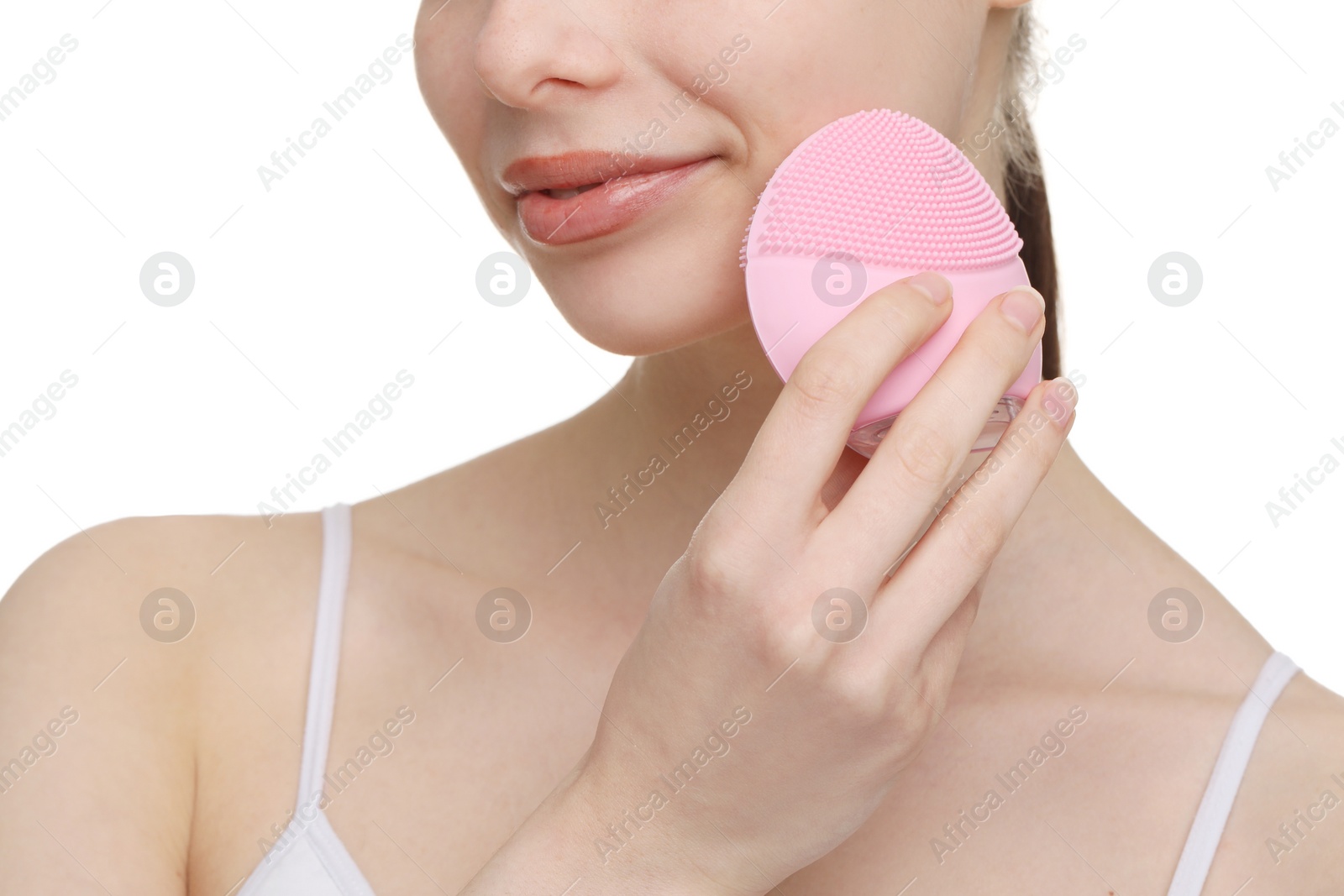 Photo of Washing face. Young woman with cleansing brush on white background, closeup