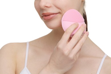Washing face. Young woman with cleansing brush on white background, closeup