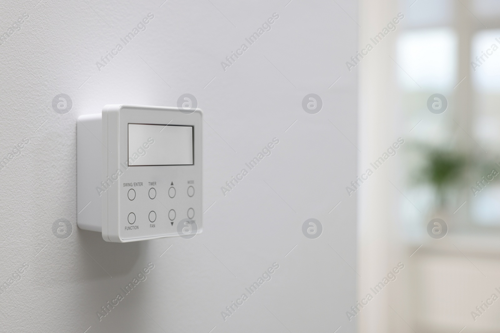 Photo of One thermostat on white wall indoors, space for text. Smart home system