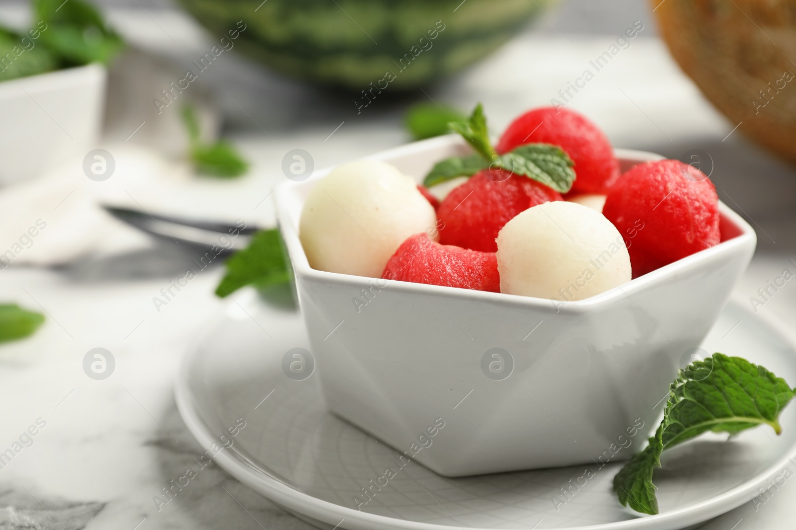 Photo of Bowl with melon and watermelon balls on table