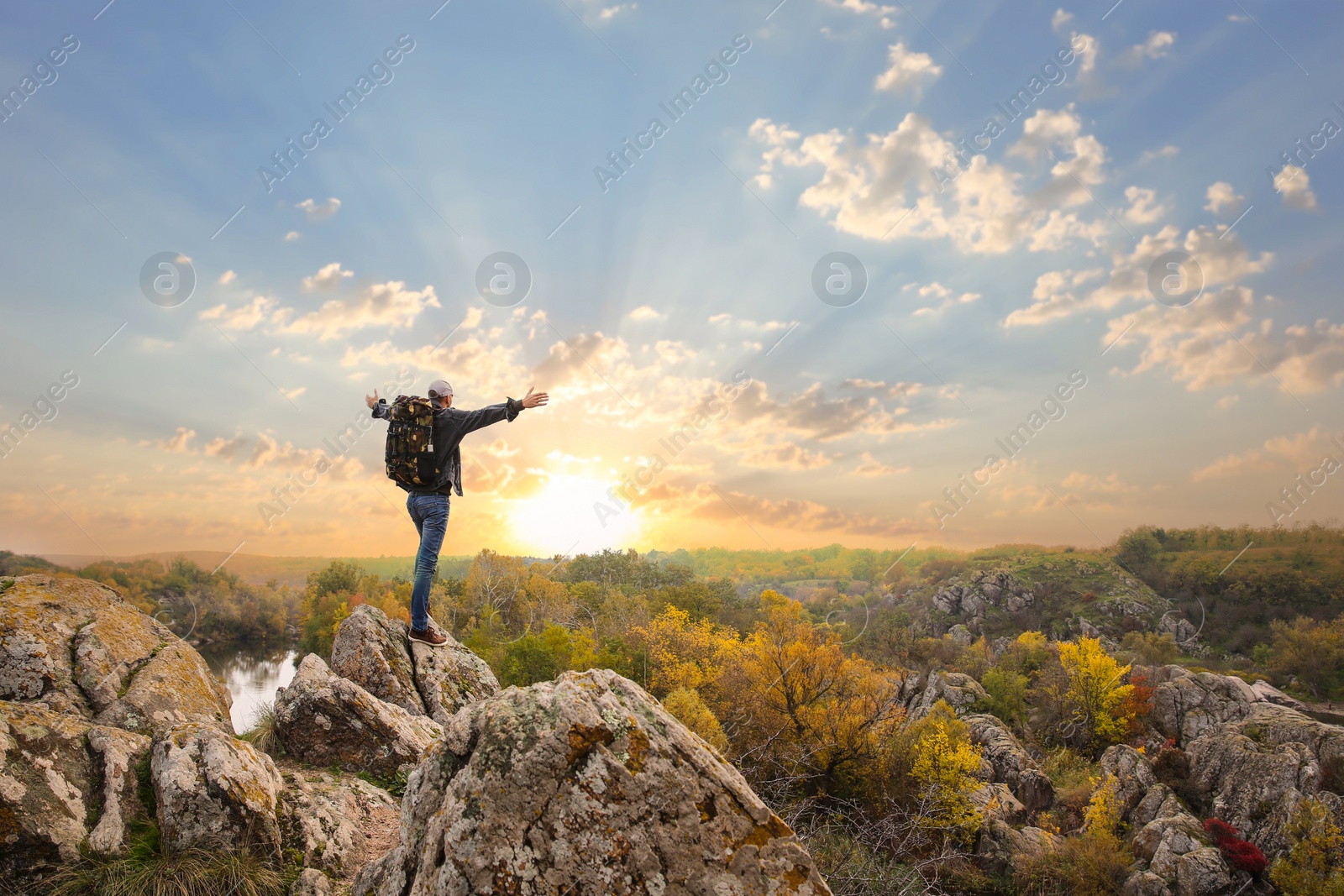 Photo of Man with travel backpack enjoying beautiful nature on autumn day