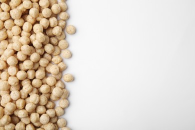 Photo of Tasty cereal balls on white background, flat lay