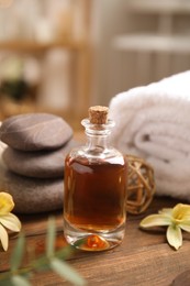 Photo of Beautiful spa composition with essential oil on wooden table indoors