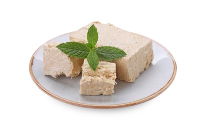 Plate with pieces of tasty halva and mint isolated on white