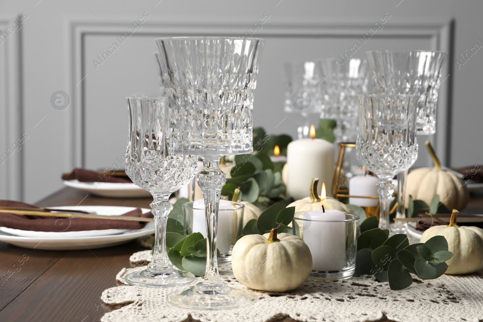 Photo of Beautiful autumn table setting. Plates, cutlery, glasses and floral decor