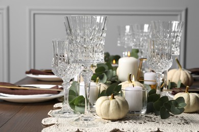 Beautiful autumn table setting. Plates, cutlery, glasses and floral decor