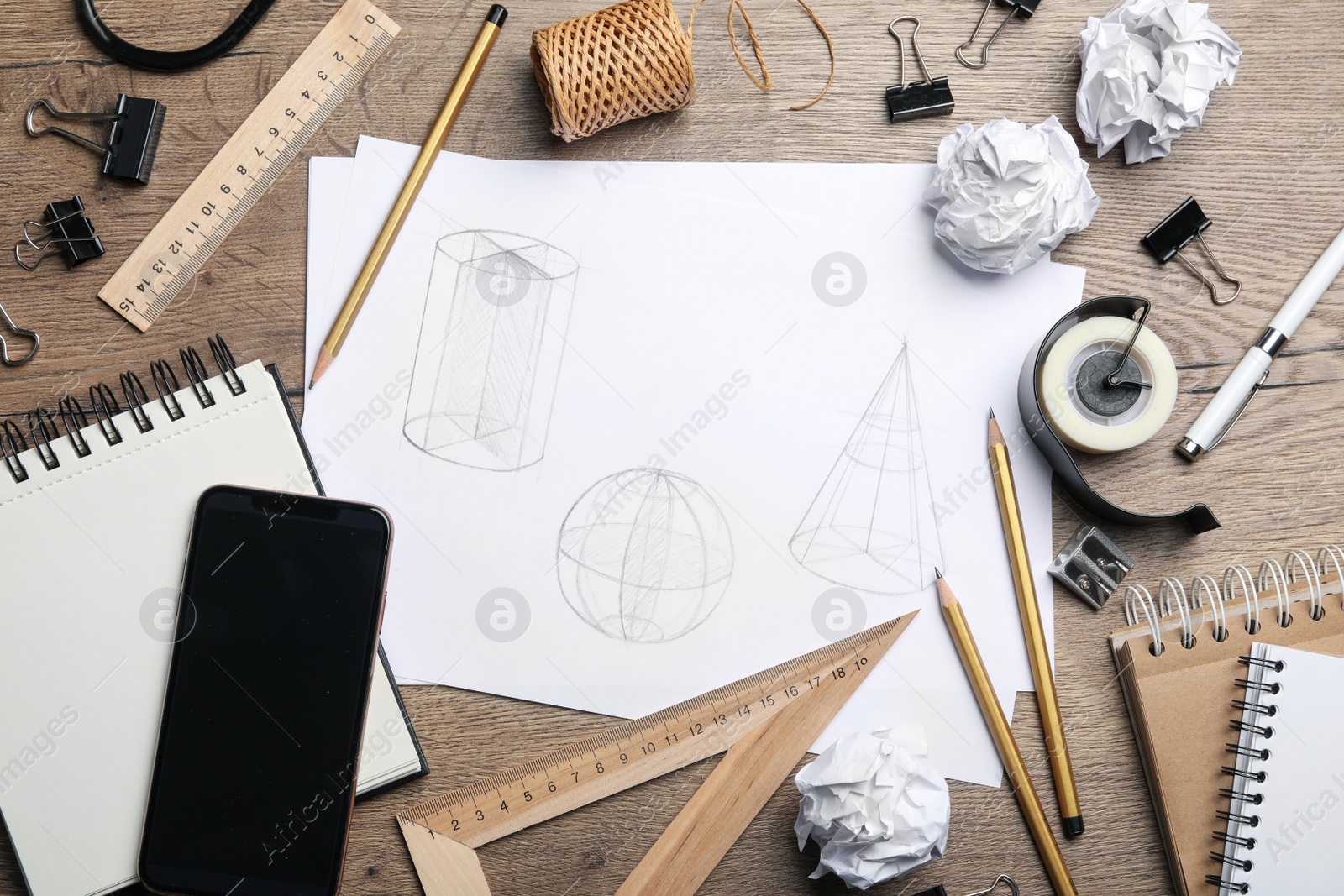 Photo of Flat lay composition with drawing of geometry shapes on wooden table. Designer's workplace