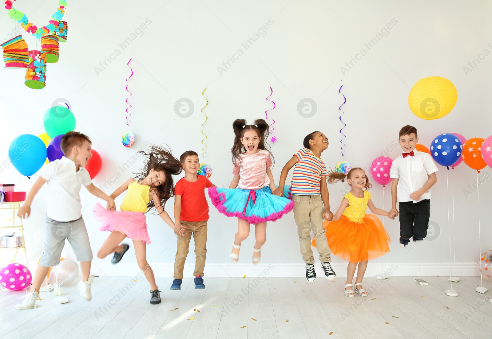 Photo of Cute little children at birthday party indoors