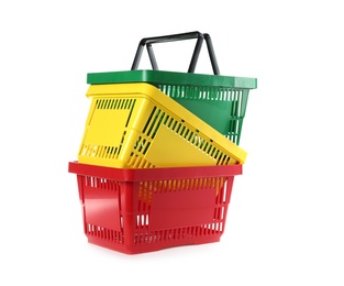 Photo of Colorful plastic shopping baskets on white background