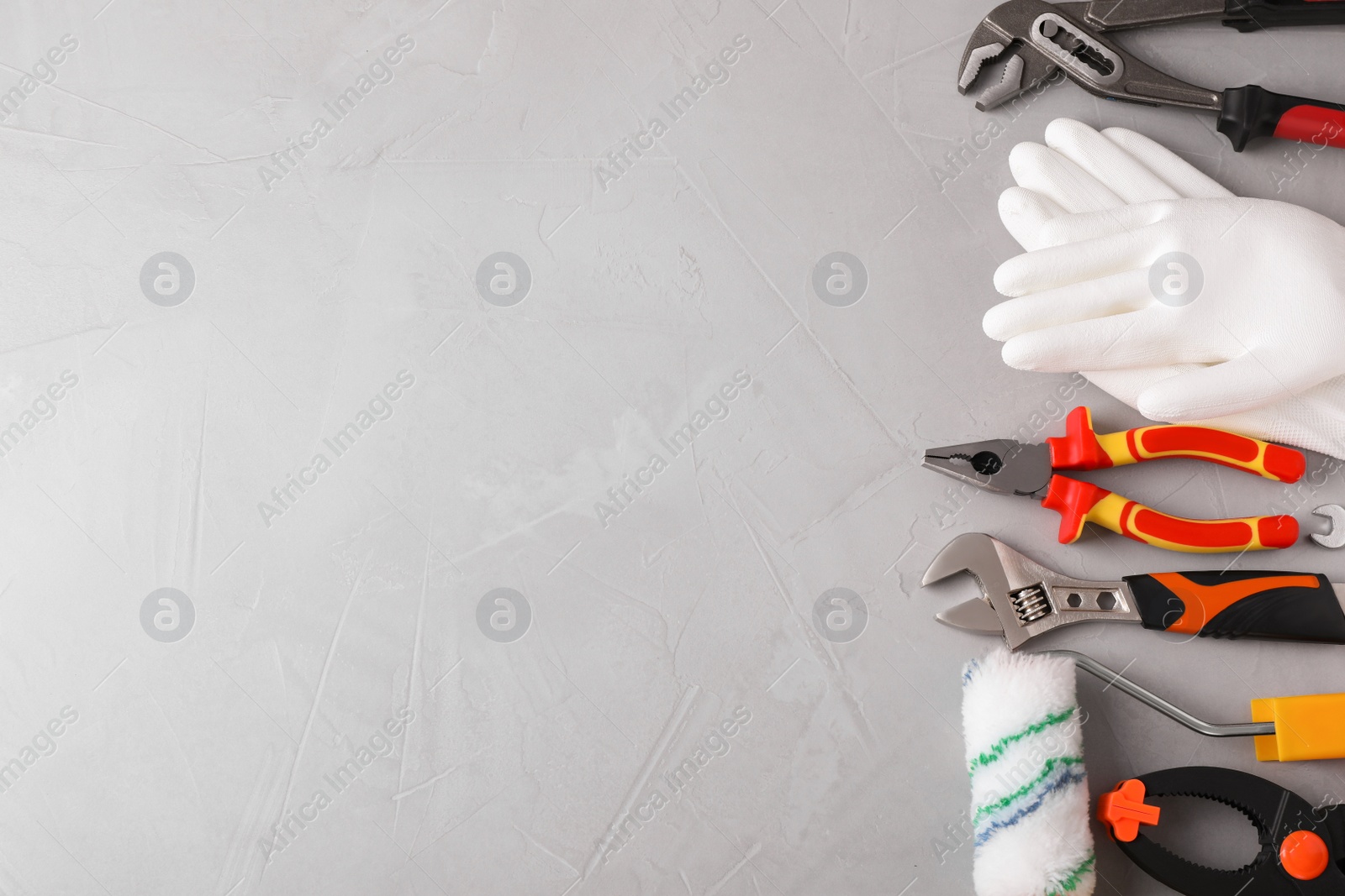 Photo of Flat lay composition with construction tools on light grey background. Space for text