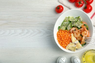 Photo of Delicious lentil bowl with shrimps, soft cheese and cucumber on white wooden table, flat lay. Space for text