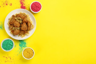 Photo of Traditional Indian food and color powders on yellow background, flat lay with space for text. Holi festival celebration