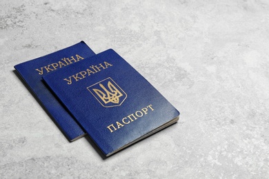 Photo of Ukrainian internal passports on grey background, space for text