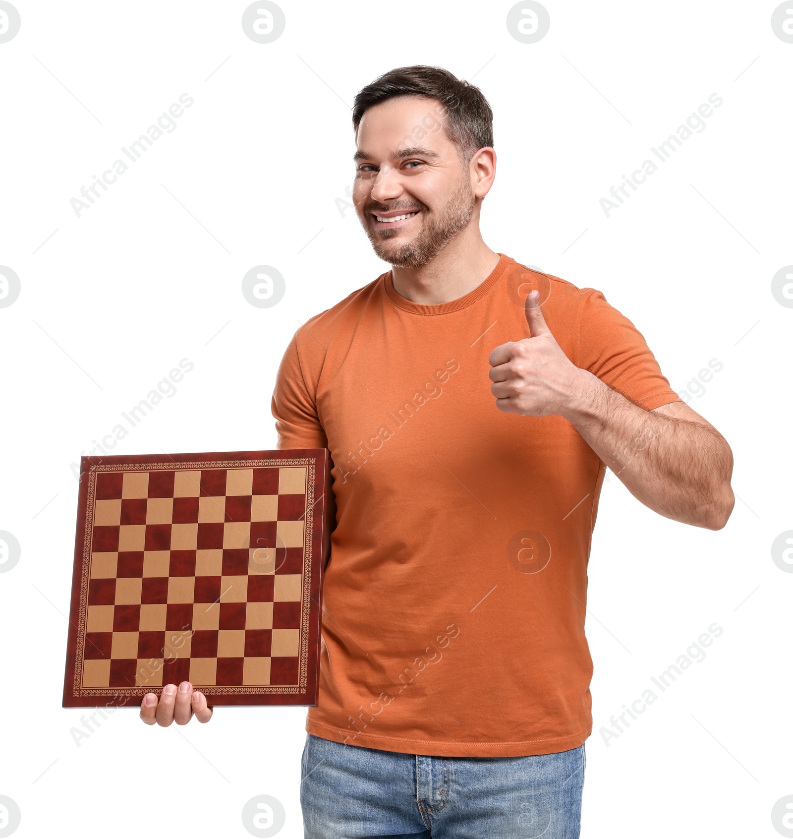 Photo of Smiling man holding chessboard and showing thumbs up on white background