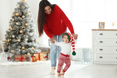 Mother and her cute baby at home. Christmas celebration