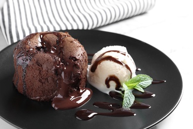 Delicious fresh fondant with hot chocolate and ice cream served on plate. Lava cake recipe