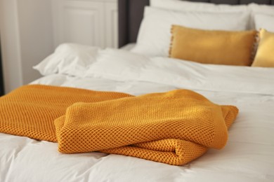 Soft orange plaid on bed in bedroom