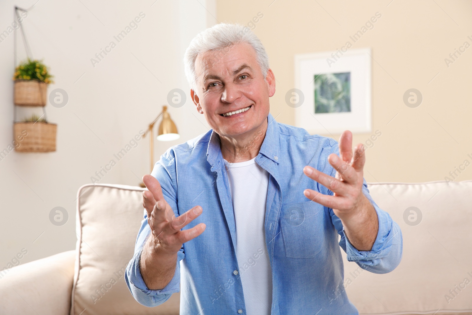 Photo of Mature man using video chat at home, view from web camera