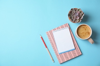 Photo of Flat lay composition with notebooks, coffee and space for text on color background