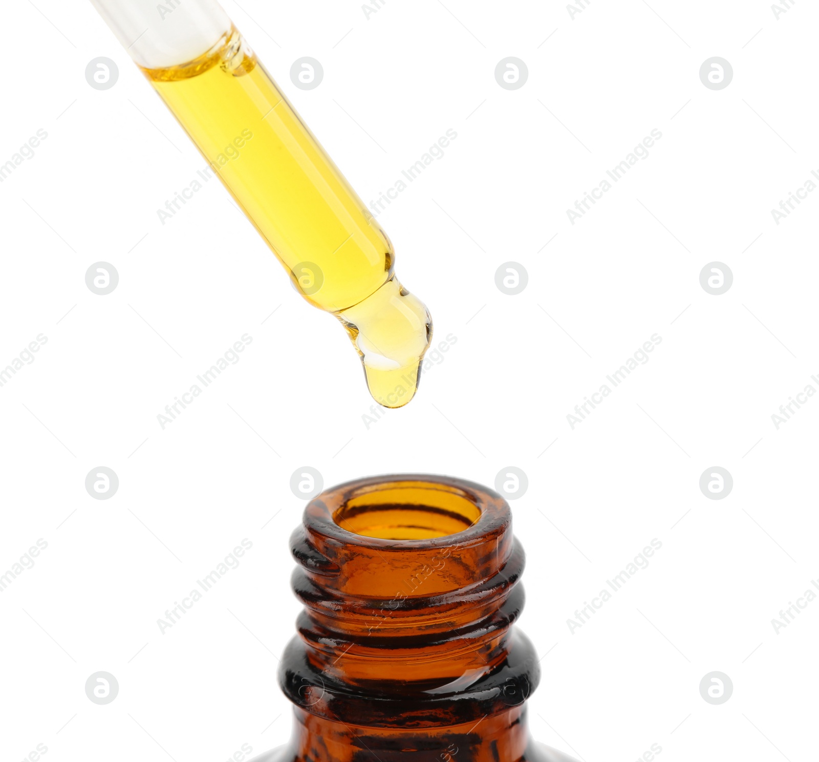 Photo of Dripping tincture from pipette into bottle isolated on white