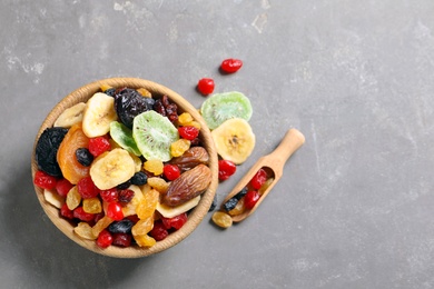 Flat lay composition with different dried fruits on grey background, space for text. Healthy lifestyle