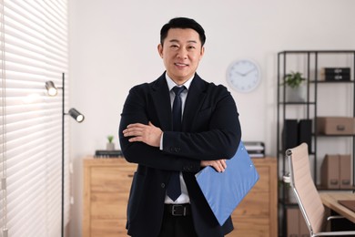 Photo of Portrait of happy notary with clipboard in office