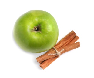 Photo of Fresh apple and cinnamon sticks on white background