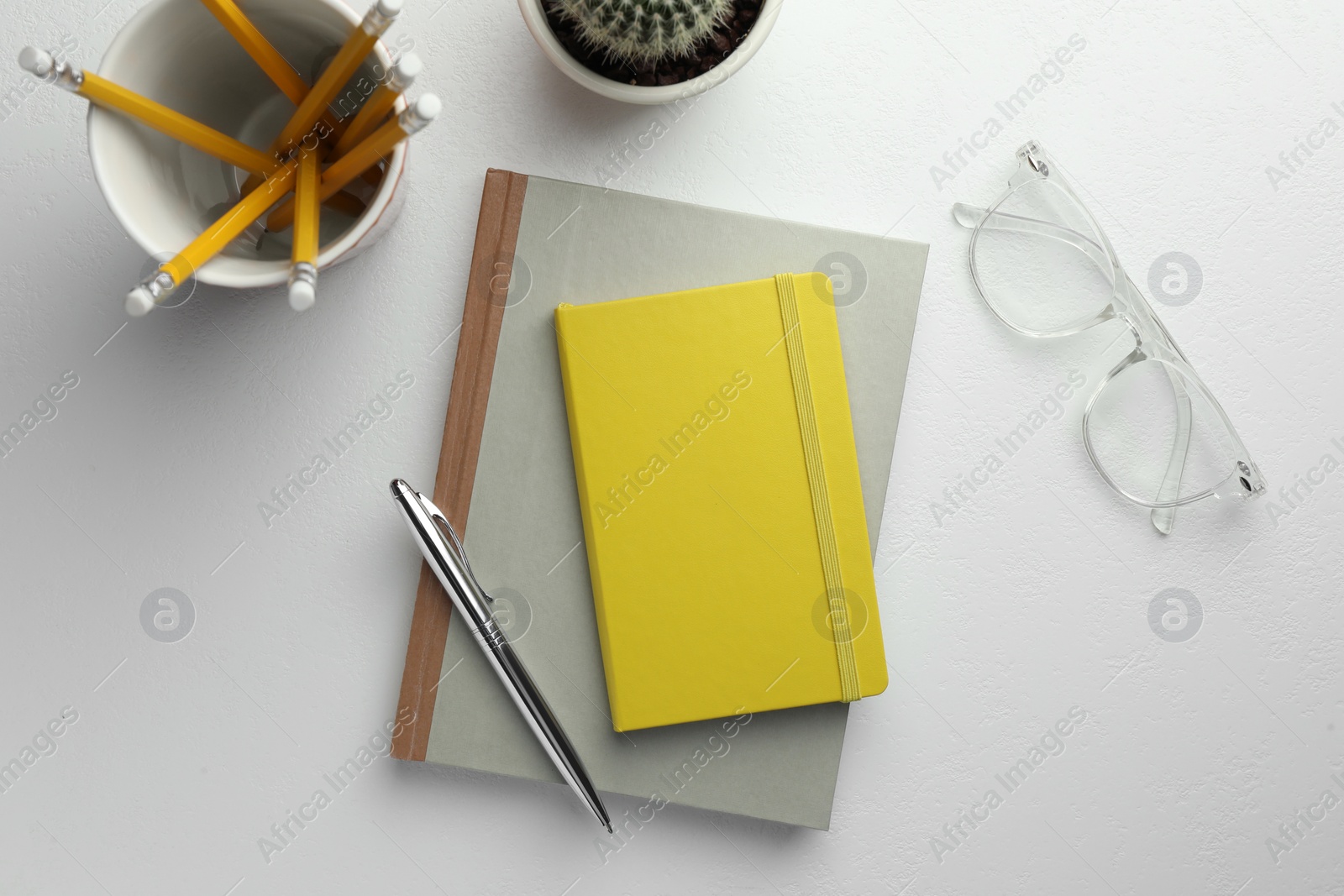 Photo of Flat lay composition with notebooks and pen on white table