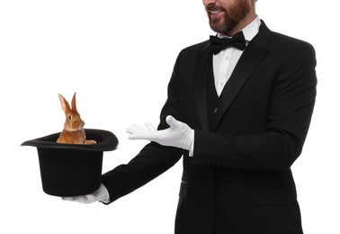 Magician showing trick with top hat and rabbit on white background, closeup