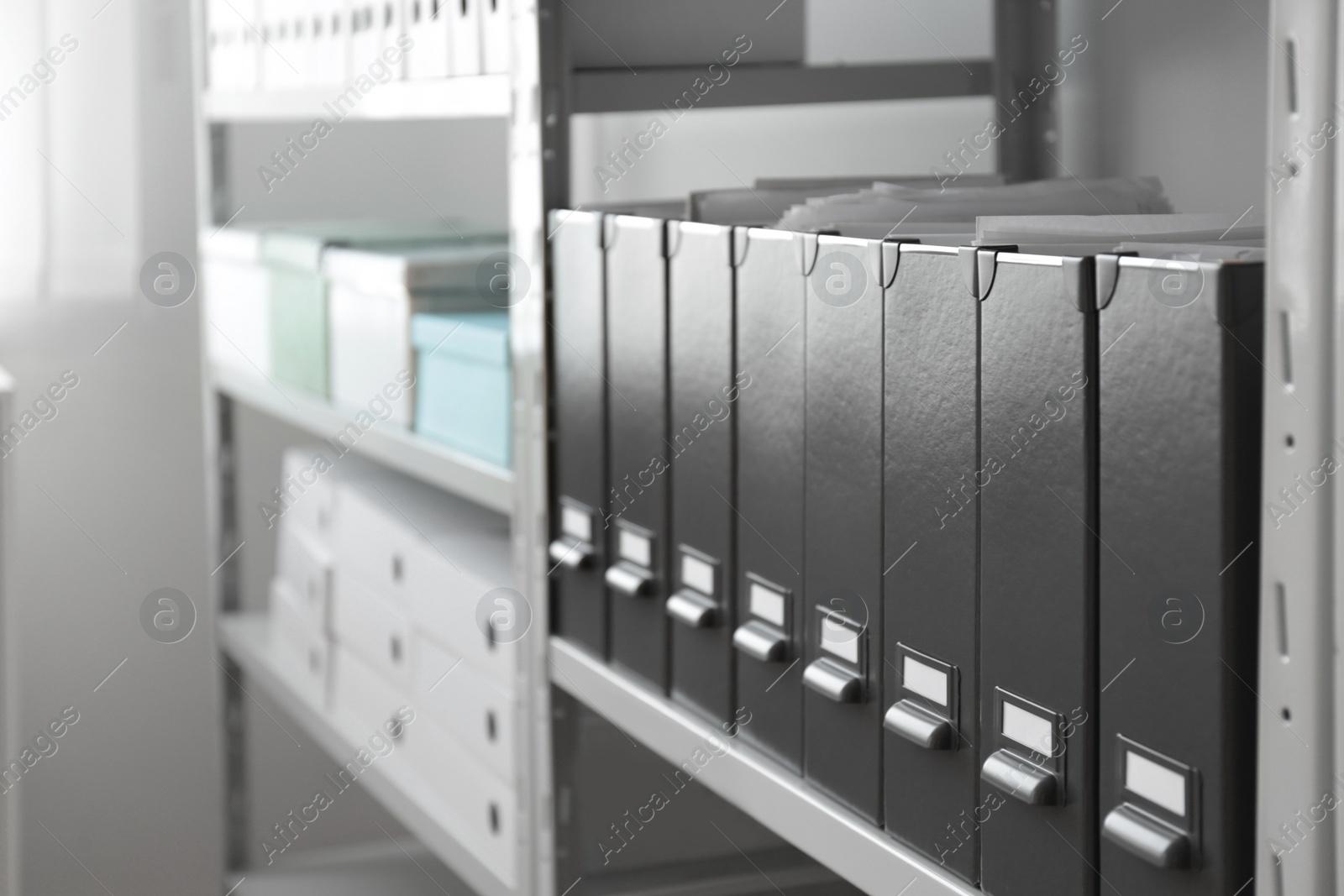 Photo of Folders with documents on shelf in archive