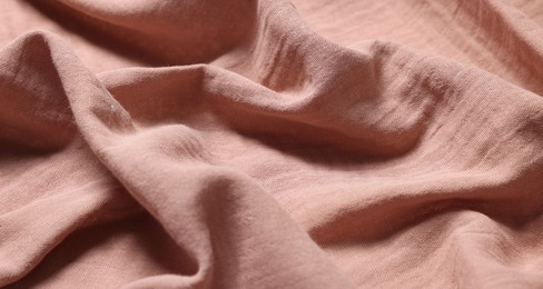 Photo of Texture of soft pastel crumpled fabric as background, closeup