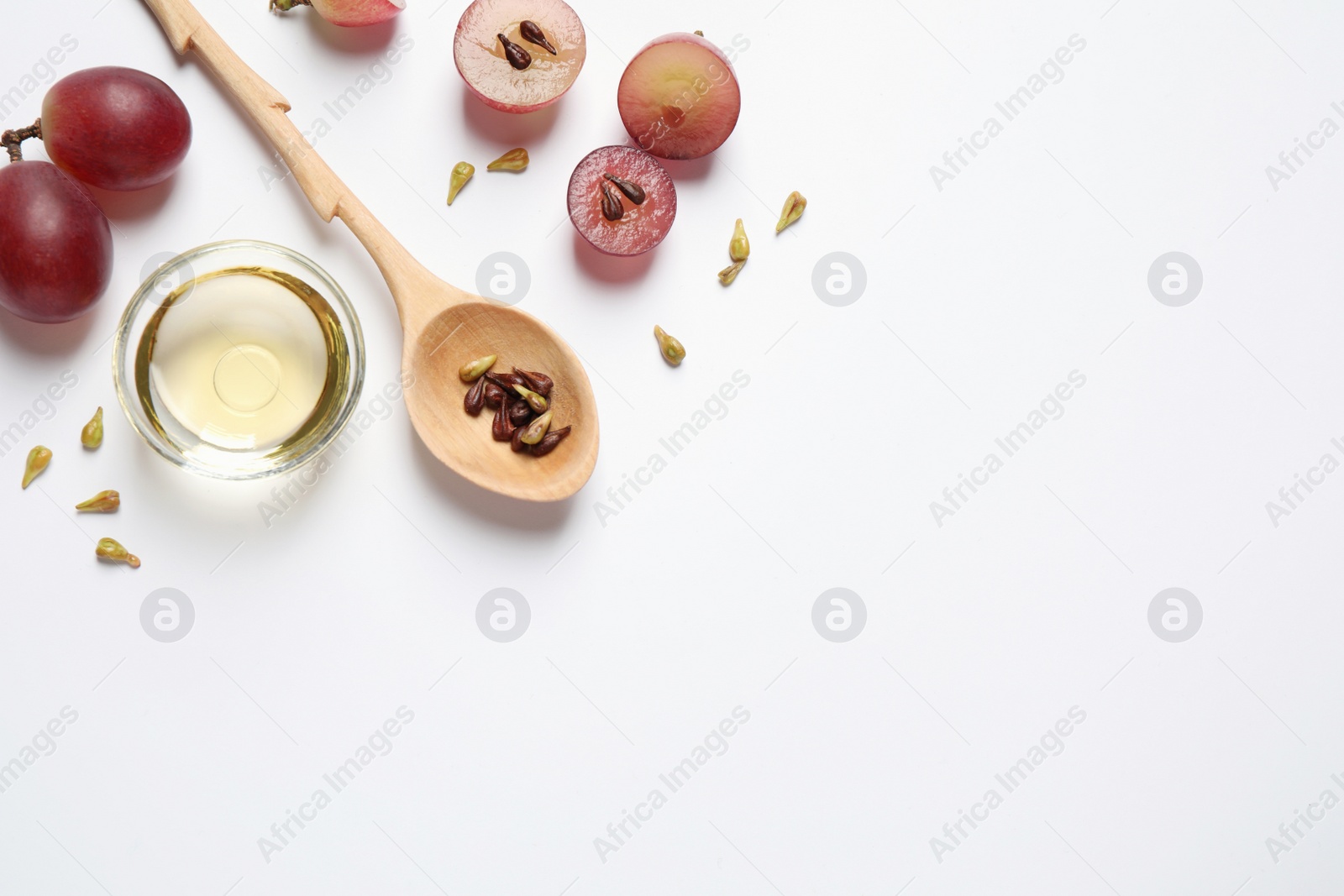 Photo of Composition with natural grape seed oil on white background, top view. Organic cosmetic