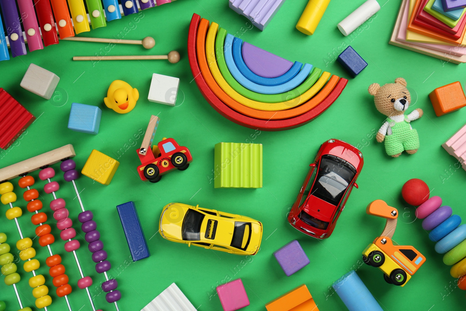 Photo of Different children's toys on green background, flat lay