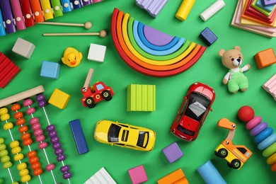 Photo of Different children's toys on green background, flat lay