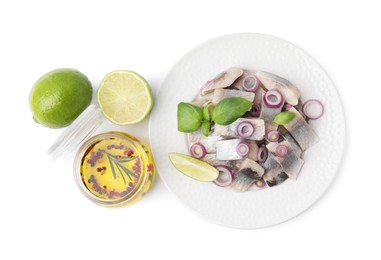 Photo of Plate with tasty fish, marinade and lime isolated on white, top view