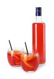 Photo of Aperol spritz cocktail, straws and orange slices in glasses isolated on white