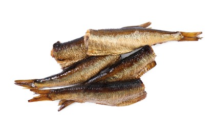Many tasty smoked sprats isolated on white, top view