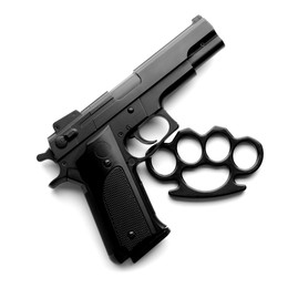 Photo of Black brass knuckles and gun on white background, top view