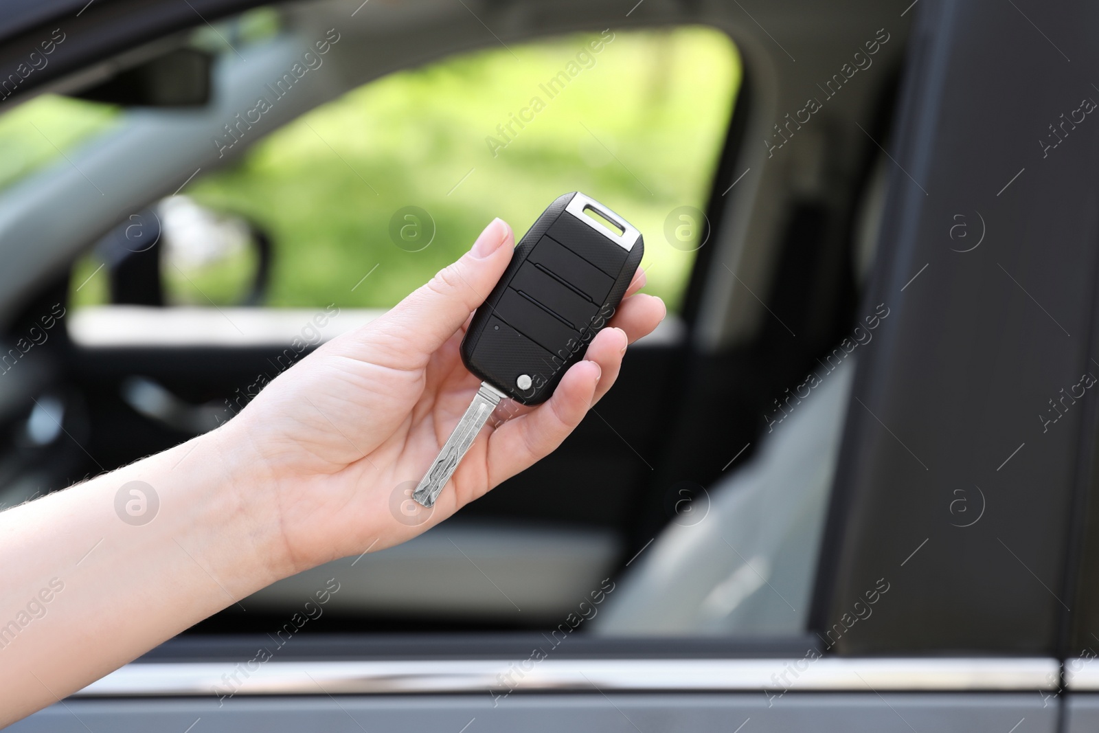 Photo of Woman with key near new car outdoors, closeup. Space for text