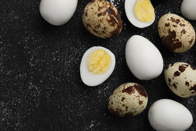 Photo of Peeled and unpeeled hard boiled quail eggs on black table, flat lay. Space for text