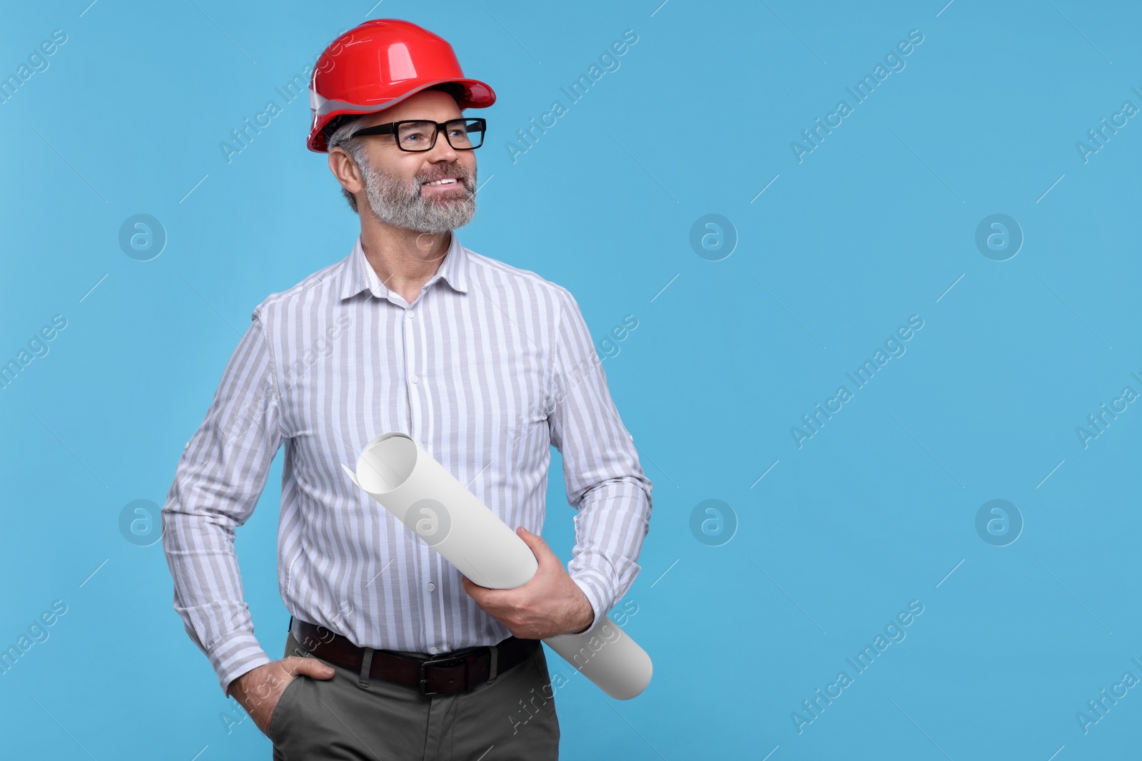 Photo of Architect in hard hat holding draft on light blue background. Space for text