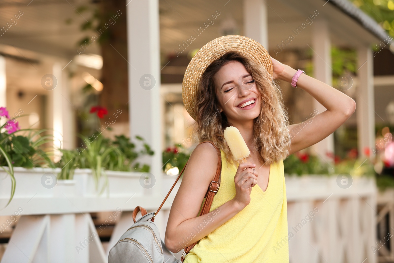 Photo of Happy young woman with delicious ice cream outdoors. Space for text