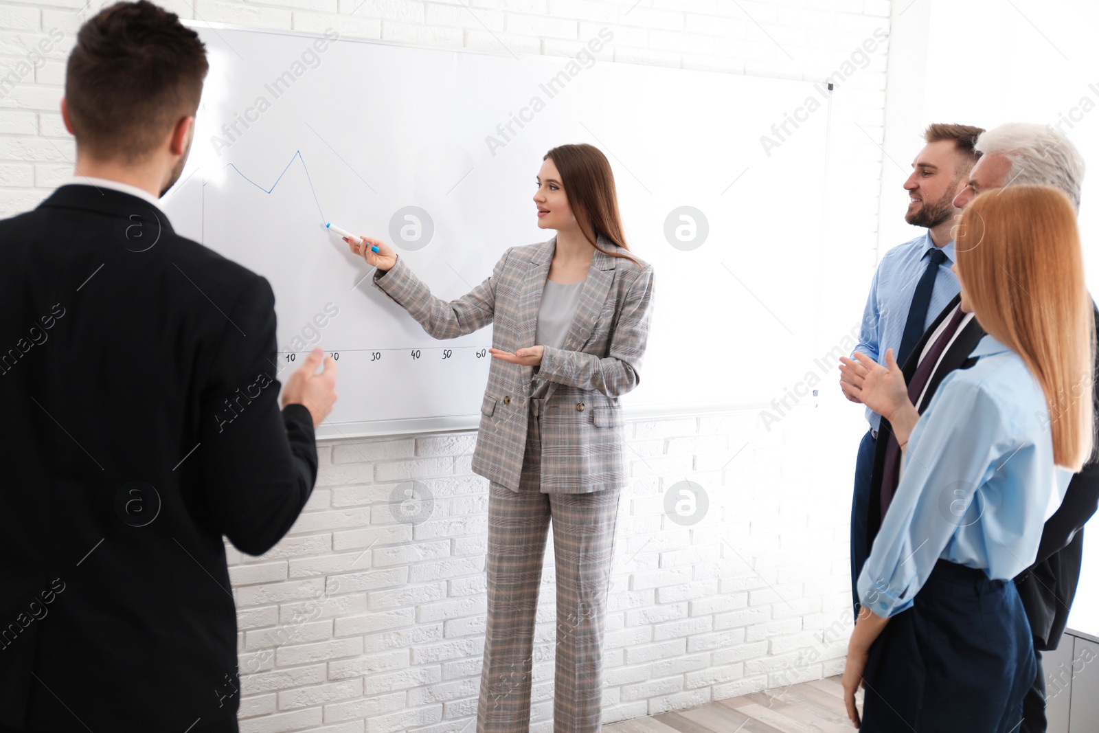 Photo of Professional business trainer working with people in office