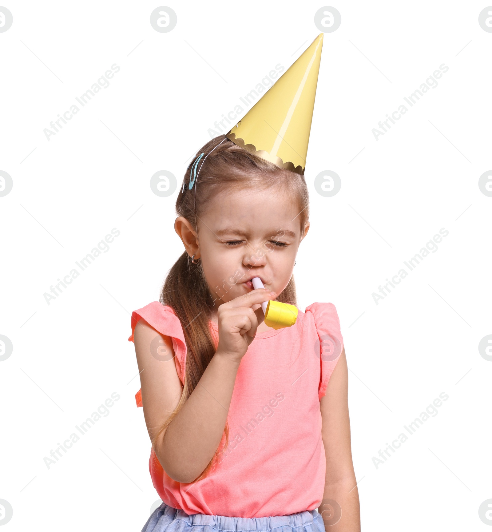 Photo of Birthday celebration. Cute little girl in party hat with blower on white background