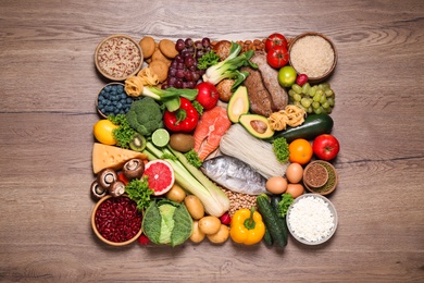 Photo of Different products on wooden table, top view. Healthy food and balanced diet