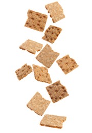 Fresh crunchy rye crispbreads falling on white background