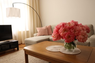 Photo of Beautiful pink peonies in vase on table at home, space for text. Interior design